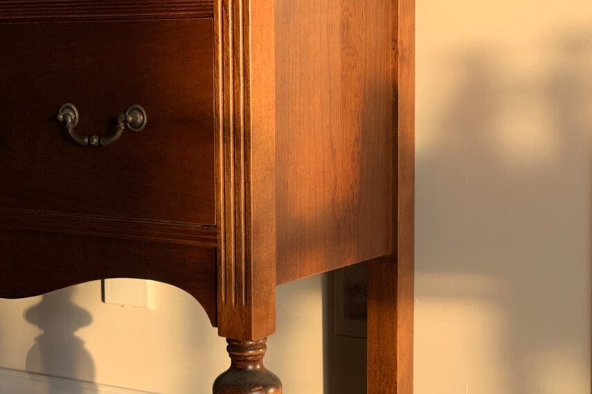 brown wooden drawer beside white wall